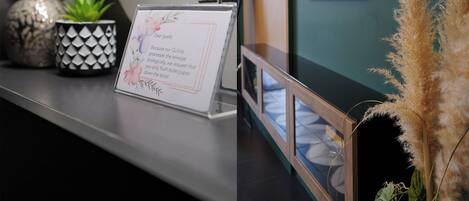 A reception desk with a sign requesting guests to flush toilet paper.