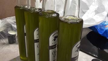 Several glass bottles with labels, some with caps, on a tiled surface.