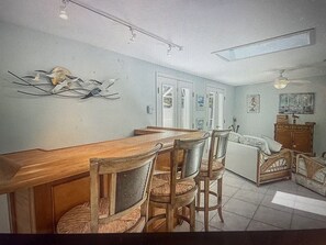 Enjoy meals in this dining area with a long table and four comfortable chairs.