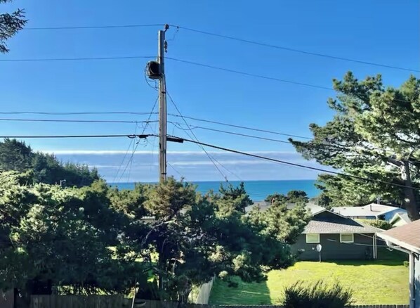 Enjoy ocean views from this residential area surrounded by lush greenery and nearby buildings.