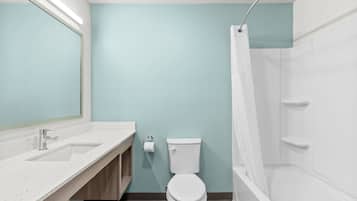 A bathroom with a white sink, toilet, and bathtub.