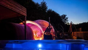 A hot tub with a wooden deck and a wooden structure in the background. - La Bulle Des Anges (Dormir à la belle étoile) (Illoud)