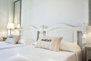 Classic hotel room with a large bed and simple, clean design.