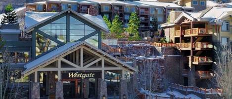 A Westgate hotel with a prominent glass facade, stone exterior, and multiple balconies.