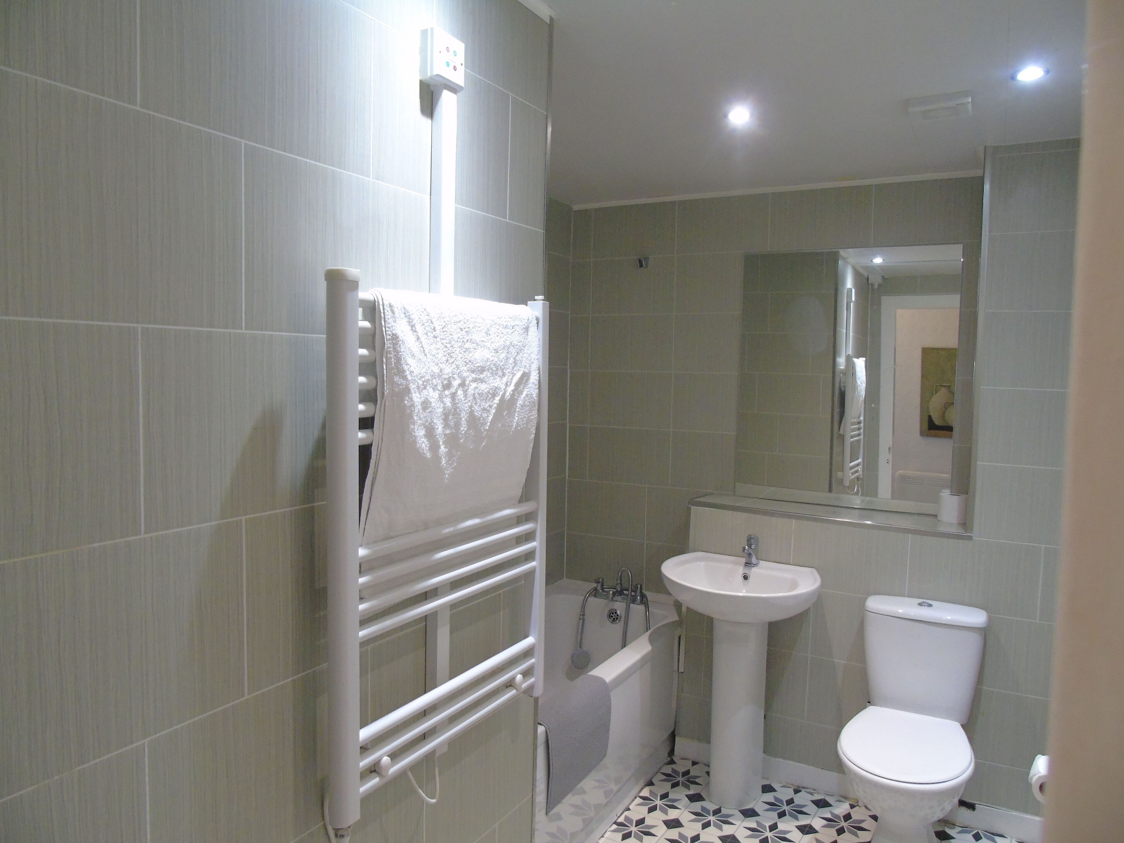 A bathroom with a bathtub, a sink, and a toilet.