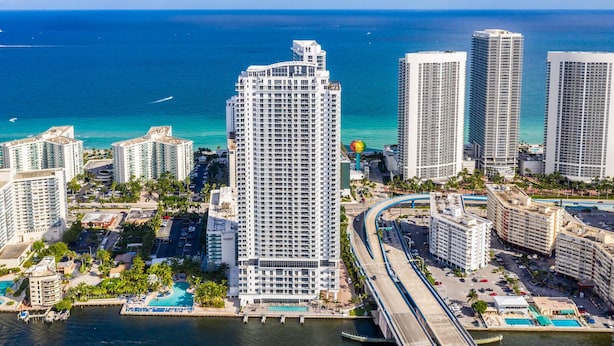 A high-rise hotel with a view of the ocean, a marina, and a bridge. - High-Floor High-Class: Luxury Oceanview,NO RESORT & PARKING FEE, CHECK DETAILS (Hollywood)