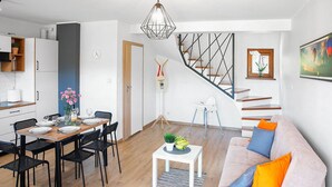 A modern apartment with a dining area, kitchen, staircase, and living room. - Awesome home in Lubkowo with WiFi (Lubkowo)