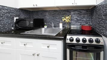 Suite, 1 King Bed with Sofa bed, Patio | Private kitchen | Full-sized fridge, microwave, oven, stovetop