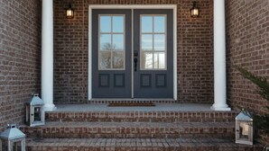 A brick house with a dark gray double door, white columns, and a small porch with steps. - Stunner Golf Course View | Walkable to Club House (Marion)
