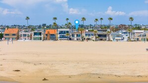 Ein Strand mit einer Reihe von Häusern und einem blauen Positionsmarker.