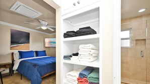 A hotel room with a bed, a wardrobe, and a shower area. - Partial Ocean View next to Boardwalk & Balboa Pier (Newport Beach)