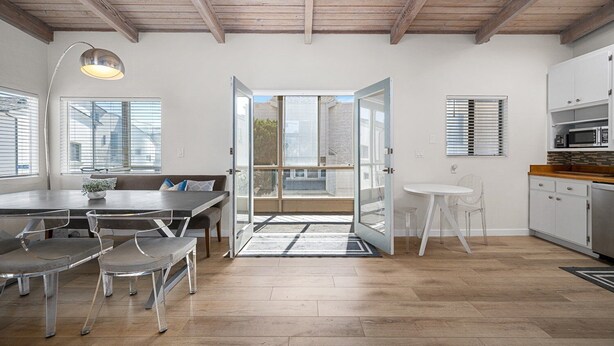 A modern kitchen with white cabinets and a wooden countertop.