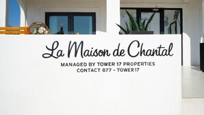 A white building with a sign reading "La Maison de Chantal" managed by Tower 17 Properties. - 1628 West Oceanfront Oasis - 4-6-7 (Newport Beach)
