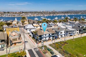 A coastal residential area with houses, a marina, and boats.