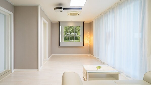 Enjoy a peaceful retreat with a view of lush greenery from the large window.