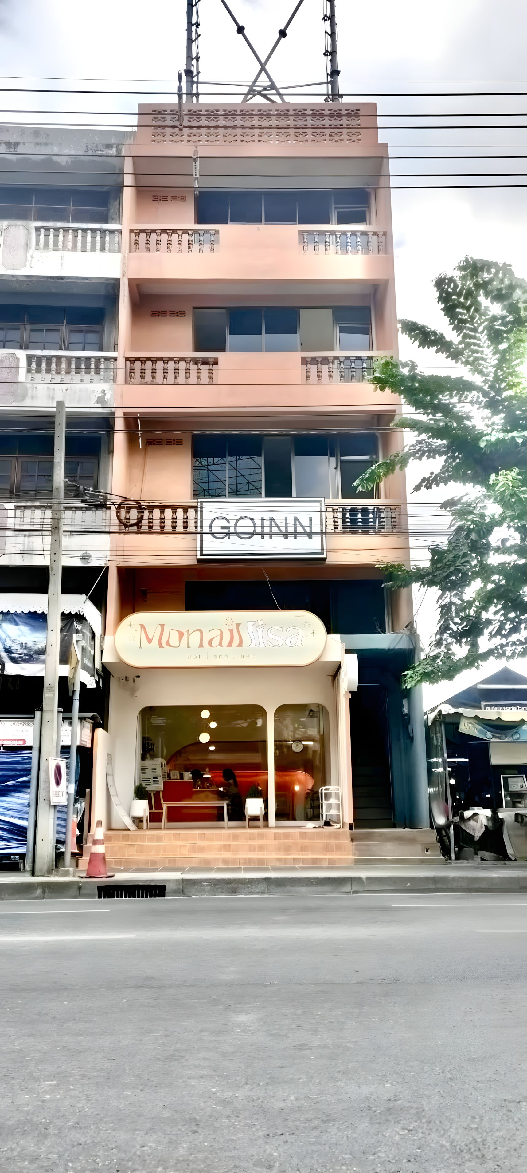 A multi-story building with a salon named 'Monalisa' on the ground floor.