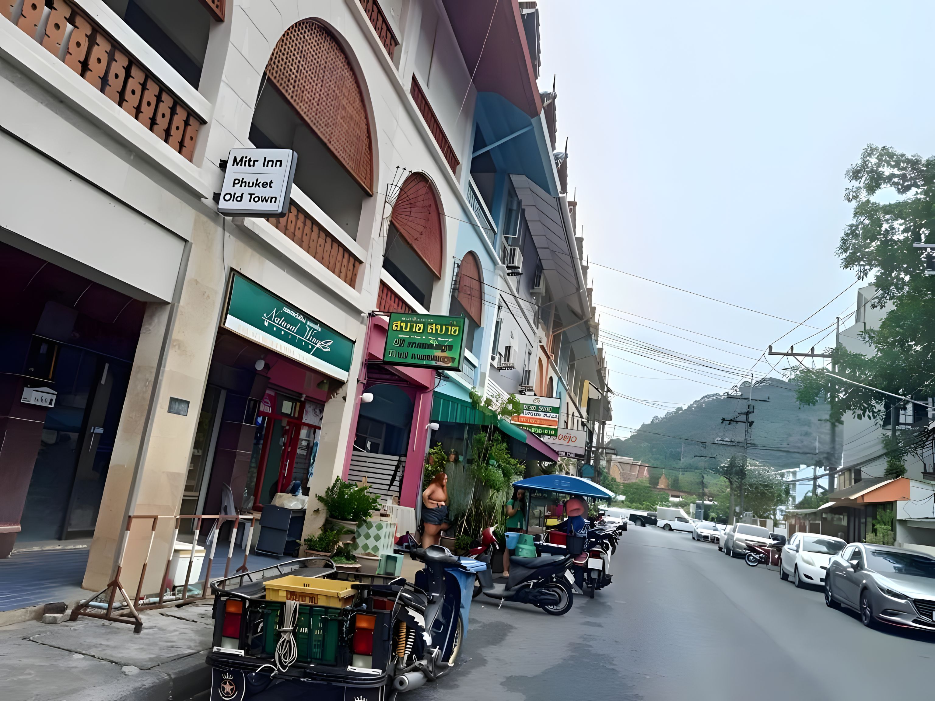 A street view with a building labeled 'Mitr Inn Phuket Old Town.'