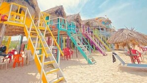 A beach with colorful wooden structures, including a staircase and seating areas. - Apt close to the Sea, Historic Center and Las Americas. (Cartagena)