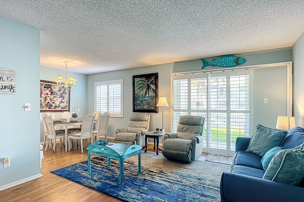 Bright and inviting living space seamlessly connected to the dining area, perfect for gatherings.