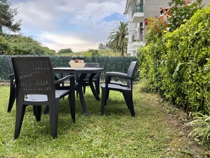 Enjoy a quiet moment outdoors with a round table and comfortable seating for four.