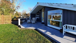 A house with a deck, outdoor furniture, and a large window. - 4 Star Holiday Home in Korsor (Korsor)