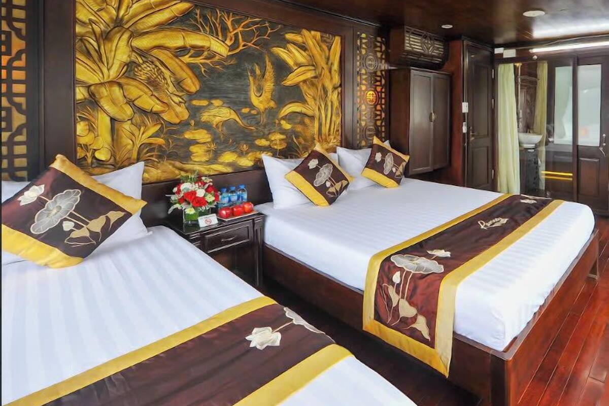 A hotel room with two beds, a large floral mural on the wall, and a wooden ceiling.