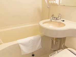 A bathroom with a sink and mirror, featuring a towel on a hook.