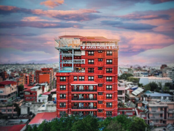 A multi-story building with a red facade and balconies, labeled as Aarya Hotel & Spa. - Aarya Hotel and Spa - Eternal Heritage (Kathmandu)