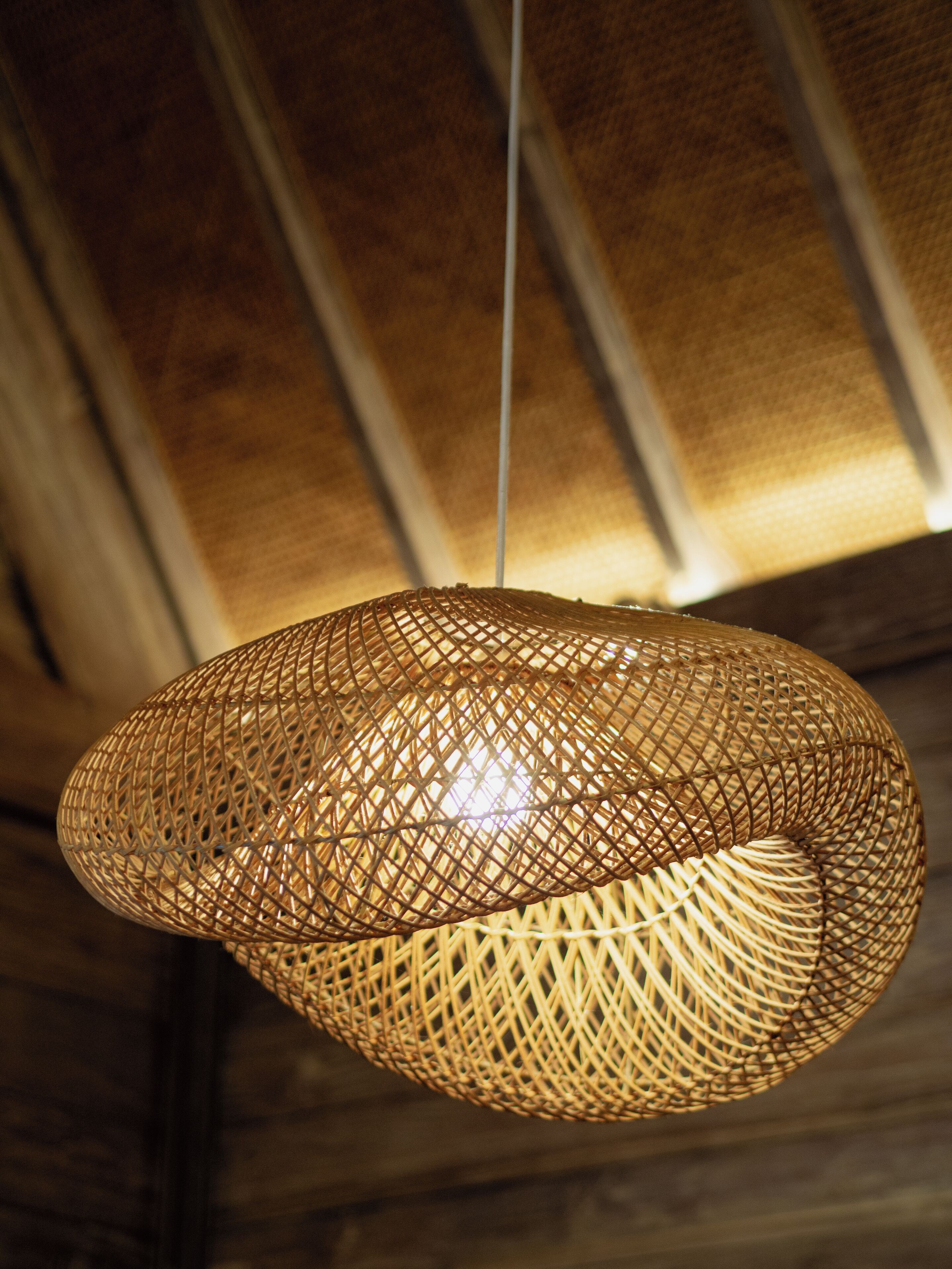 A woven pendant light fixture hanging from the ceiling.