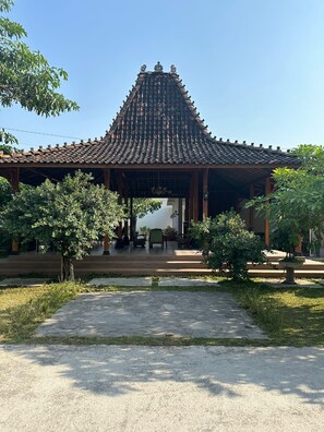 A traditional pavilion with a tiled roof, surrounded by greenery and a paved walkway. - Kinkeo Borobudur (Borobudur)