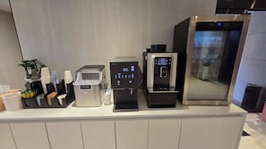 A coffee machine, a water dispenser, and a trash bin on a counter. - Its HOTEL (Jeonju)