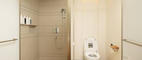A compact bathroom with a shower, toilet, and storage shelves.