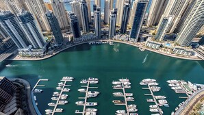A marina with numerous boats docked, surrounded by high-rise buildings. - EDEN’S Homes & Villas - VIDA Dubai Marina Residences (Dubai)