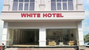 A multi-story building with a sign reading "WHITE HOTEL" at the top and bottom. - White Hotel (Thanh Vinh)