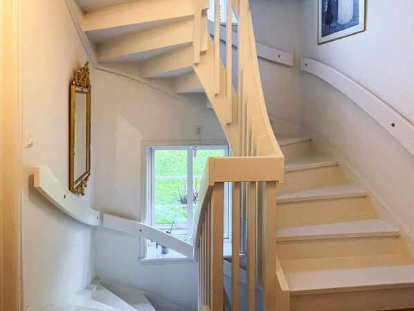 A staircase with white railings and a window at the top. - 5 Star Holiday Home in Uddevalla (Uddevalla)