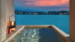 A pool with a view of a cityscape at dusk.