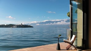 A balcony with a view of the sea and a distant island.