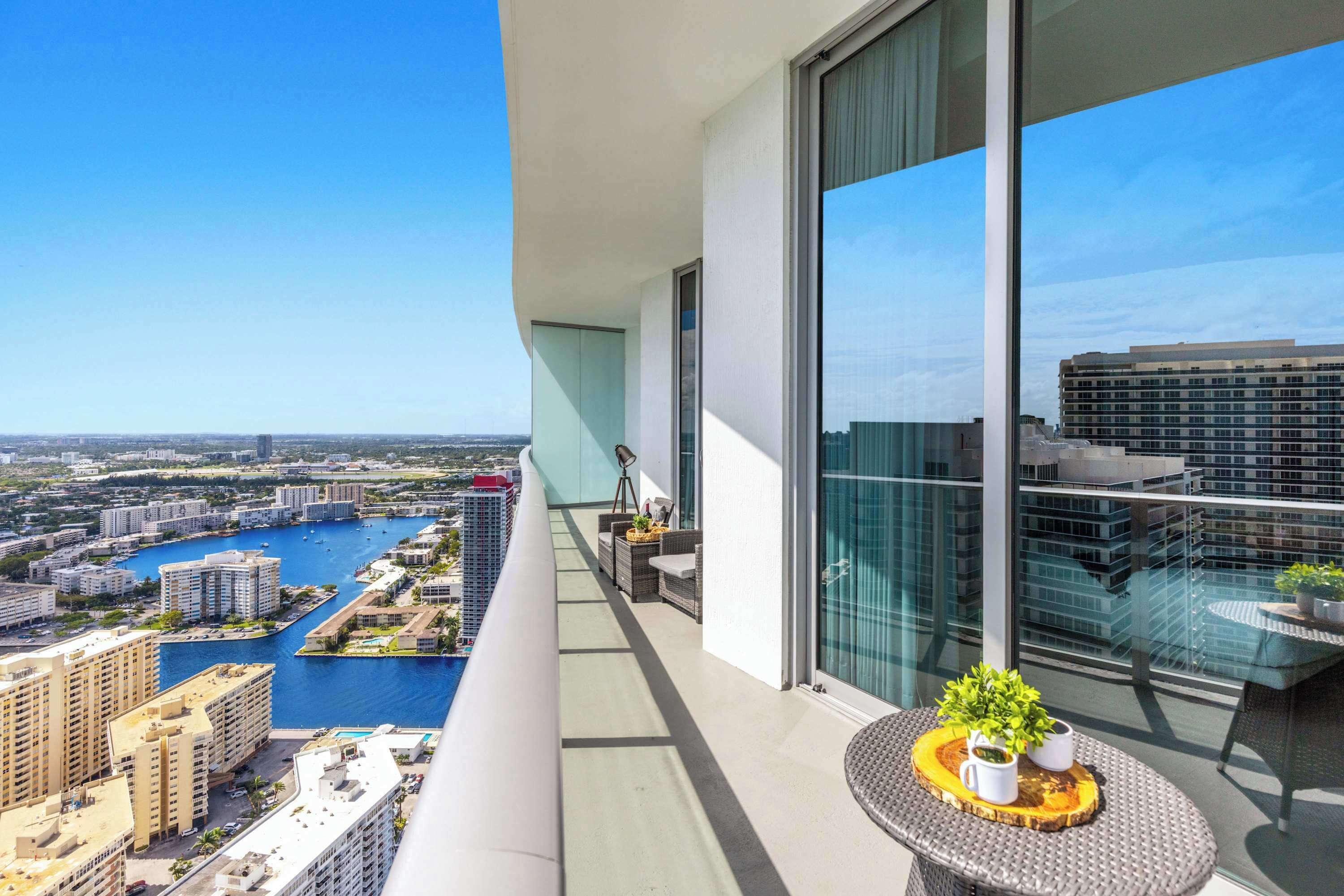 A balcony with a view of a marina and cityscape.