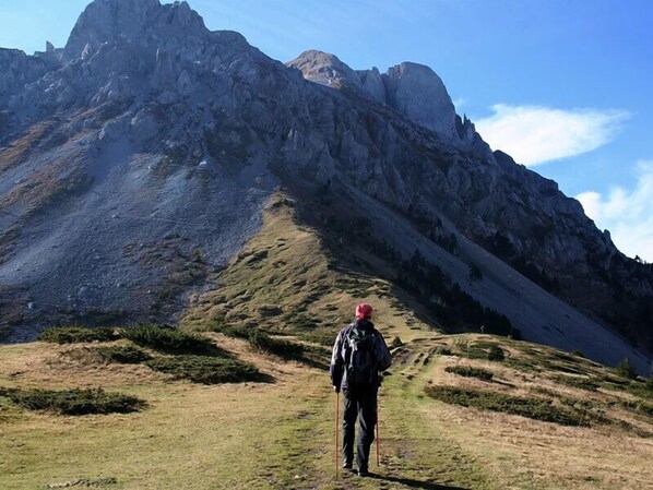 A hiker on a mountain trail with rocky terrain and sparse vegetation. - Wulfenia Hotel & Spa (Kolašin)