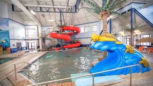 An indoor swimming pool with slides and a water slide structure. - Eagles Nest • Mtn Views • Dog-Friendly • Ev Charger • Ski/Hike (Silverthorne)