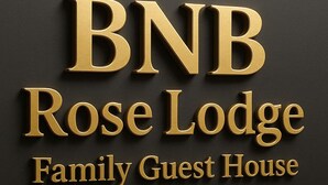 A logo with the text "BNB Rose Lodge Family Guest House" in a 3D gold font on a dark background. - BNB Rose Lodge Family Guest House (Karachi)