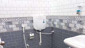 A bathroom with a toilet, bidet, and sink. - BNB Rose Lodge Family Guest House (Karachi)