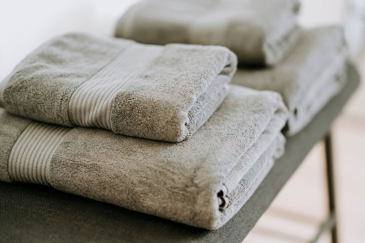 Neatly folded towels stacked on a table.