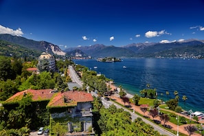 A coastal town with a prominent church, a small island, and a clear blue sky.