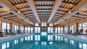 An indoor swimming pool with wooden beams and large windows. - Arc 1950: 10 guests, 4 bdr, ski-in/ski-out (Les Arcs 1950)