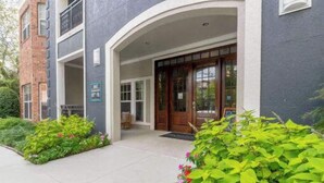 A building entrance with a wooden door and a small porch area.