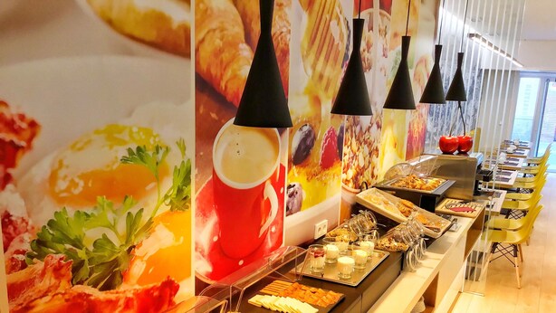 A buffet area with various food options, including meats, cheeses, and desserts. - Hotel Miau  (Madrid)