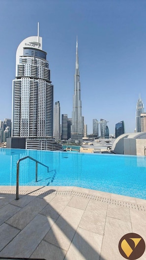 A pool area with a view of the Burj Khalifa and surrounding high-rise buildings.