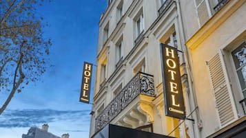 A hotel named 'Hotel Clémence' with a classic European architectural style, featuring balconies and large windows.