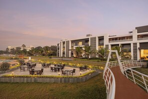 A modern hotel with outdoor seating and a bridge. - Ginger Diu Jalandhar Beach (Diu)